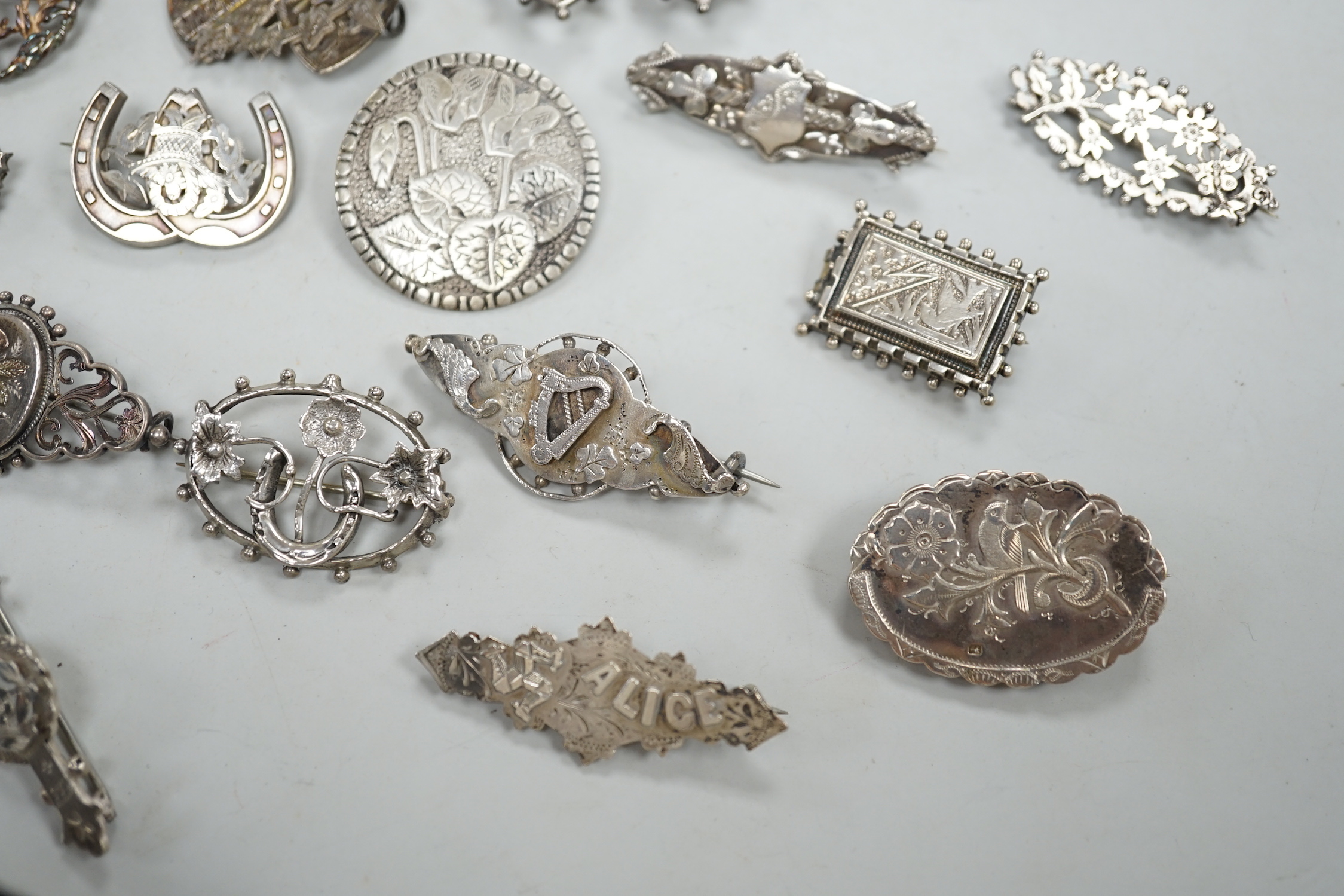 A small collection of twenty nine assorted Victorian and later silver or white metal brooches.